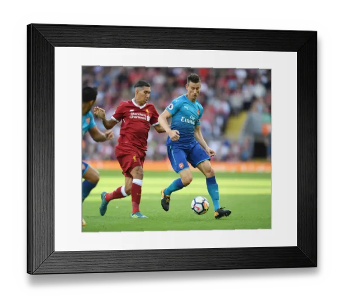 Framed Print : Koscielny vs. Firmino: A Premier League Battle at Anfield Framed Print : Koscielny vs. Firmino: A Premier League Battle at Anfield