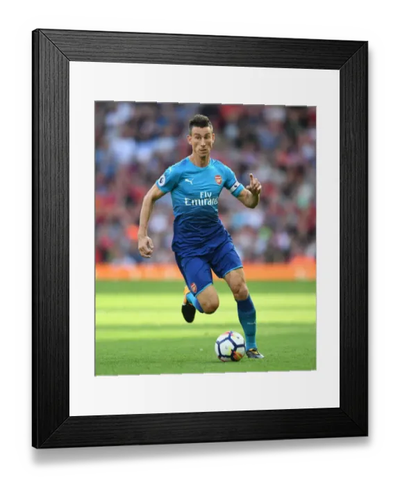 Framed Print : Laurent Koscielny Faces Off at Anfield: Liverpool vs. Arsenal, 2017-18 Premier League