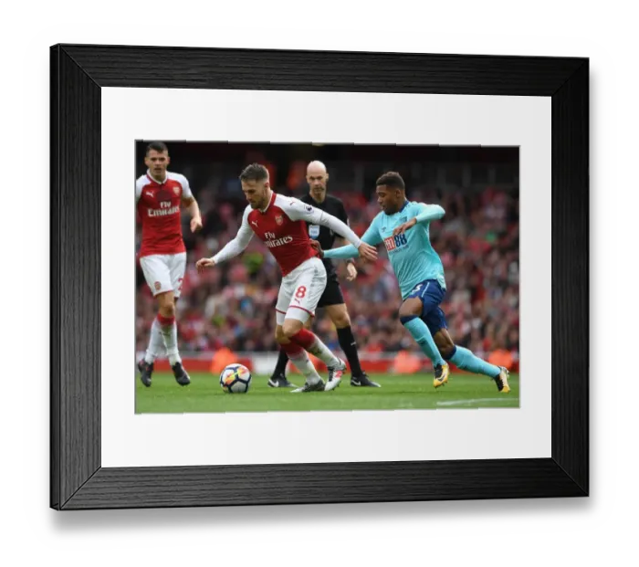 Framed Print : Arsenal's Aaron Ramsey Clashes with Bournemouth's Jordon Ibe in Premier League Showdown