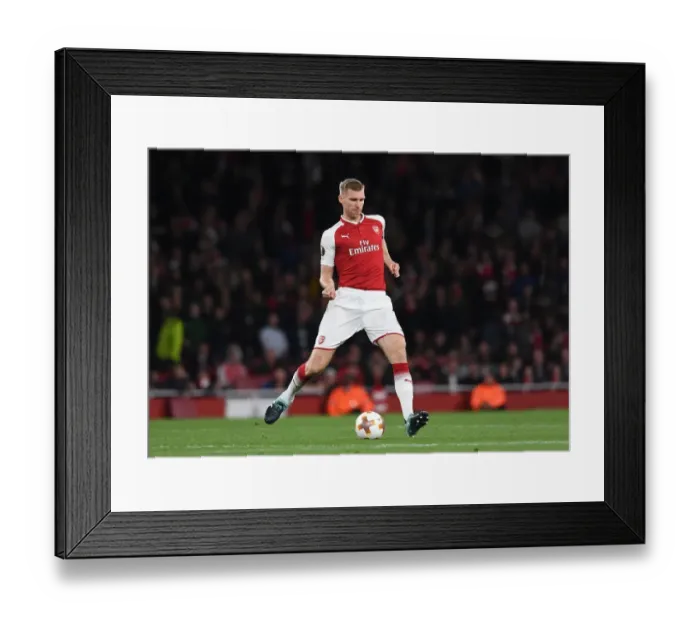 Framed Print : Per Mertesacker's Unwavering Focus: Arsenal's Defensive Wall Against 1. FC Koeln in Europa League