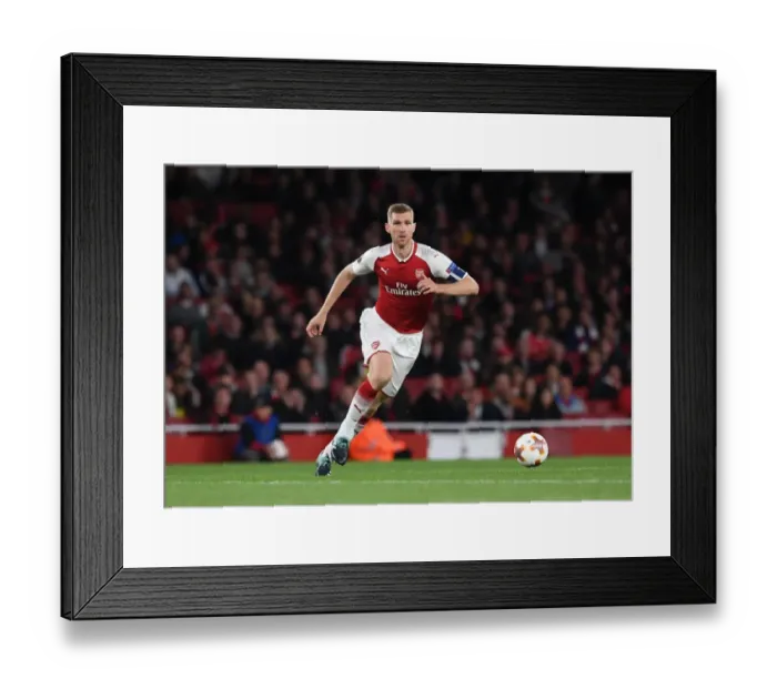 Framed Print : Per Mertesacker Focuses in Arsenal's Europa League Clash Against 1. FC Koeln