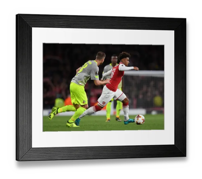 Framed Print : Reiss Nelson vs. Matthias Lehmann: Clash in the Europa League between Arsenal and 1. FC Koeln