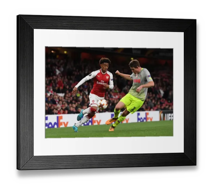 Framed Print : Reiss Nelson vs. Dominique Heintz: Clash in the Europa League between Arsenal and 1. FC Koeln Framed Print : Reiss Nelson vs. Dominique Heintz: Clash in the Europa League between Arsenal and 1. FC Koeln