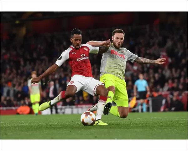 Theo Walcott vs Jorge Mere: Intense Moment in Arsenal v FC Köln UEFA Europa League Clash