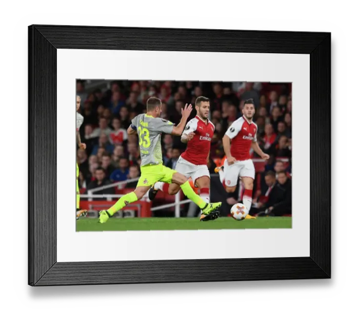 Framed Print : Arsenal's Jack Wilshere Clashes with 1. FC Koeln's Matthias Lehmann in Europa League Showdown