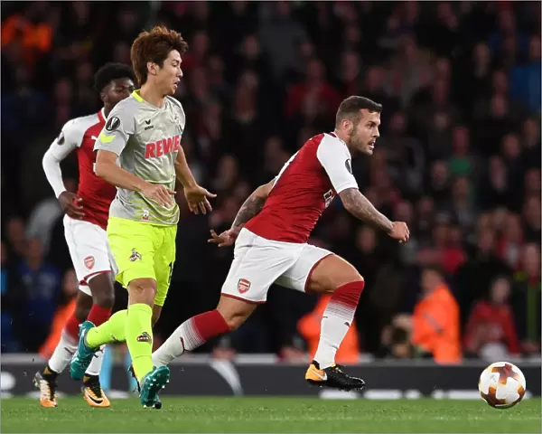 Arsenal's Jack Wilshere Clashes with FC Köln's Yuya Osako in Europa League Showdown