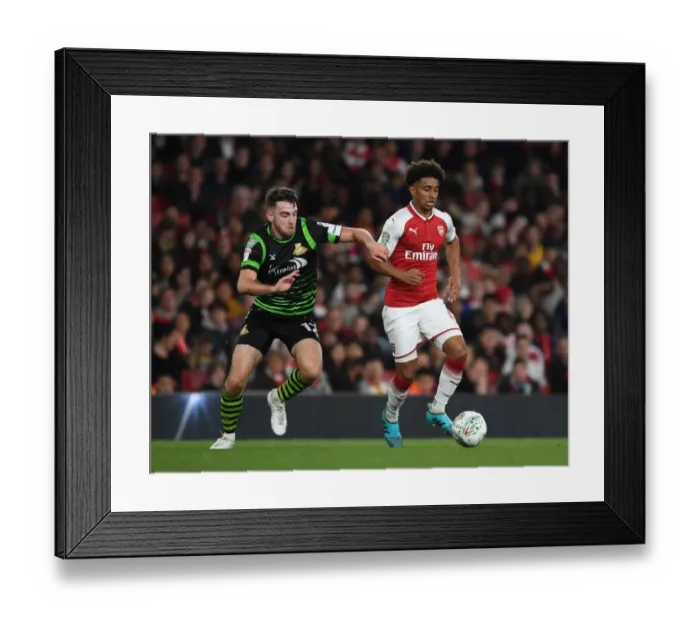 Framed Print : Reiss Nelson Outmaneuvers Ben Whiteman in Arsenal's Carabao Cup Victory Framed Print : Reiss Nelson Outmaneuvers Ben Whiteman in Arsenal's Carabao Cup Victory