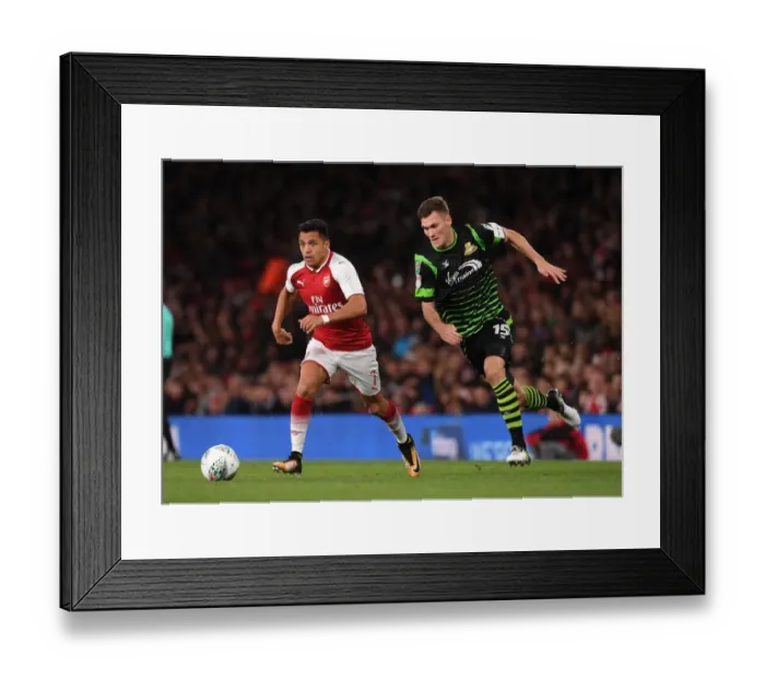 Framed Print : Alexis Sanchez vs. Joe Wright: Arsenal's Star Forward Clashes with Doncaster's Defender in Carabao Cup Showdown