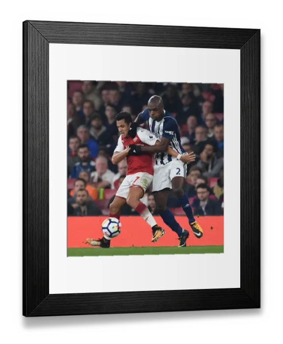 Framed Print : Intense Battle: Sanchez vs. Nyom in Arsenal's Premier League Clash Framed Print : Intense Battle: Sanchez vs. Nyom in Arsenal's Premier League Clash