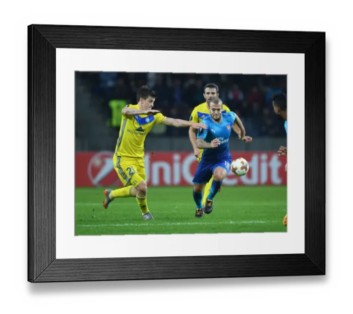 Framed Print : Wilshere vs. Dragun: A Europa League Battle - Arsenal's Jack Wilshere Takes on FC BATE Borisov's Stanislav Dragun Framed Print : Wilshere vs. Dragun: A Europa League Battle - Arsenal's Jack Wilshere Takes on FC BATE Borisov's Stanislav Dragun