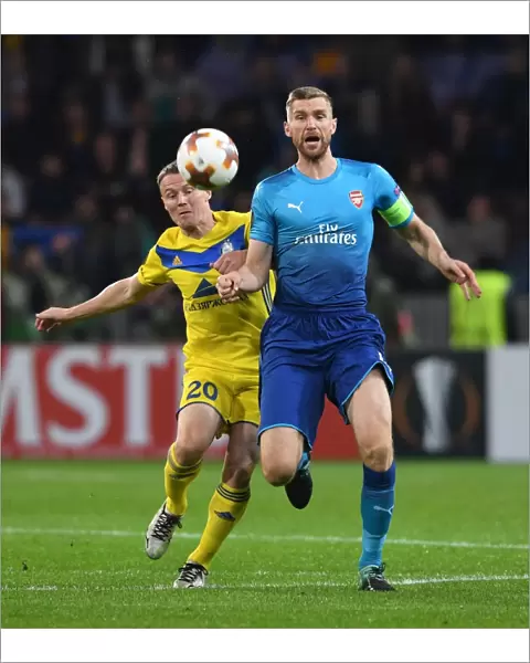 Per Mertesacker vs. Vitali Rodionov: A Battle in the UEFA Europa League between Arsenal FC and BATE Borisov