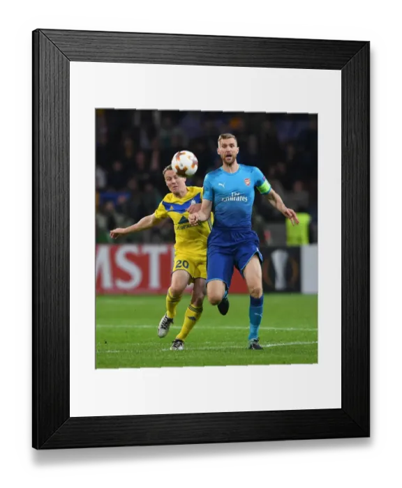 Framed Print : Per Mertesacker vs. Vitali Rodionov: A Battle in the UEFA Europa League between Arsenal FC and BATE Borisov