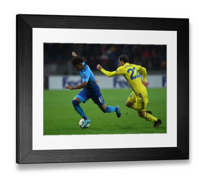 Framed Print : Reiss Nelson vs Igor Stasevich: Battle in the Europa League between Arsenal FC and BATE Borisov