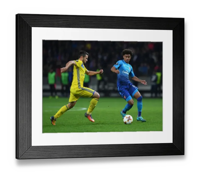 Framed Print : Reiss Nelson vs Aleksandr Volodko: Battle in the Europa League between Arsenal and BATE Borisov