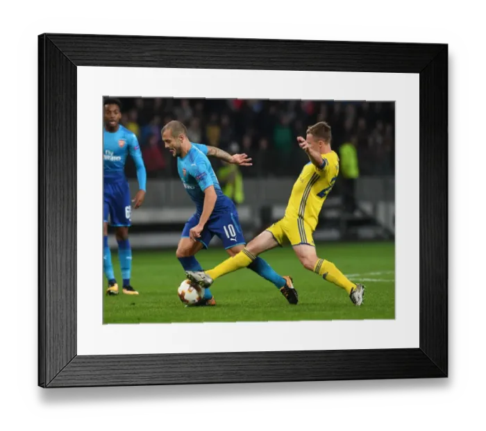 Framed Print : Wilshere vs Rodionov: Europa League Clash between Arsenal and BATE Borisov