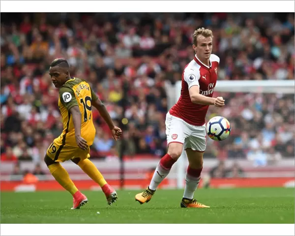 Arsenal's Rob Holding Battles Jose Izquierdo in Premier League Clash