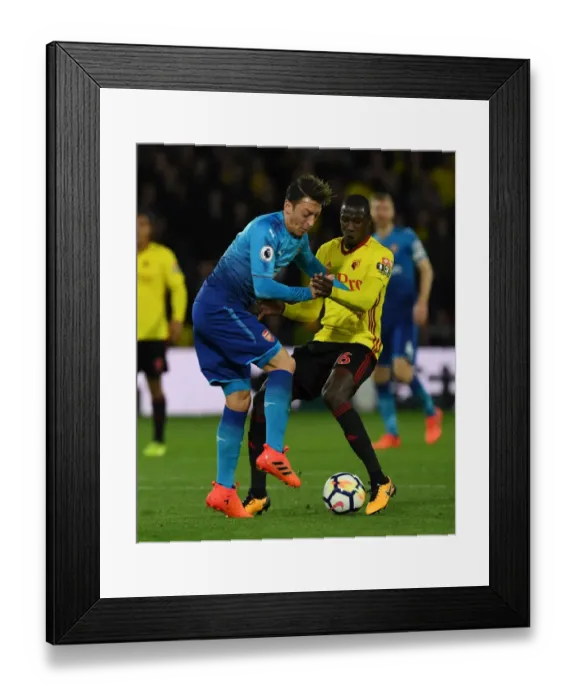 Framed Print : Clash on the Pitch: Ozil vs. Doucoure - Watford vs. Arsenal, Premier League 2017-18 Framed Print : Clash on the Pitch: Ozil vs. Doucoure - Watford vs. Arsenal, Premier League 2017-18