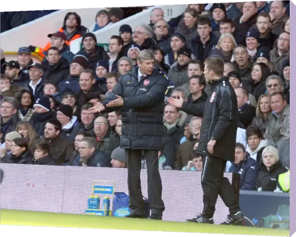 Arsene Wenger the Arsenal Manager talks with the 4th official
