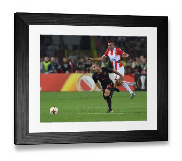 Framed Print : Jack Wilshere Overpowers Nenad Krsticic: Arsenal's Midfield Maestro Shines in Europa League Clash against Crvena Zvezda