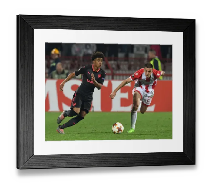 Framed Print : Reiss Nelson vs Milan Rodic: Clash in the Europa League between Crvena Zvezda and Arsenal