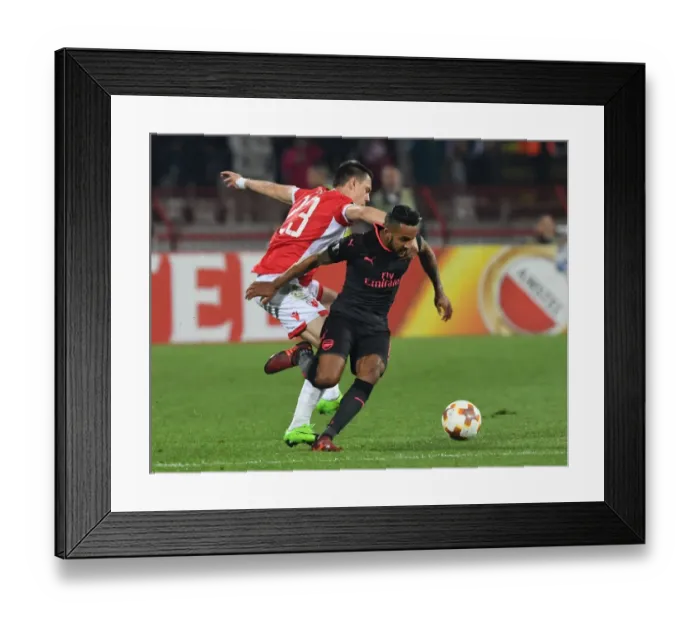 Framed Print : Theo Walcott vs Milan Rodic: A Battle in the Europa League between Crvena Zvezda and Arsenal FC