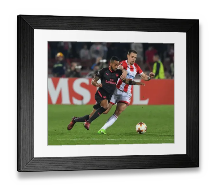 Framed Print : Theo Walcott vs Milan Rodic: A Europa League Battle at Rajko Mitic Stadium