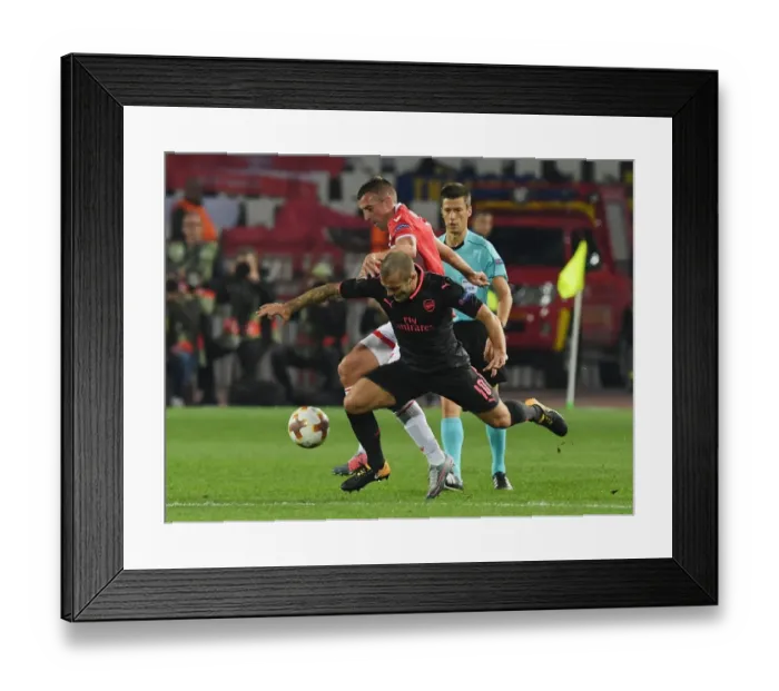 Framed Print : Jack Wilshere's Dominance: Overpowering Nenad Krsticic in the Europa League Clash between Arsenal and Crvena Zvezda