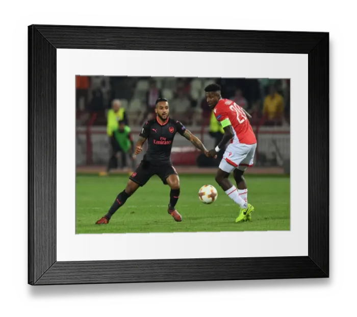 Framed Print : Theo Walcott vs. Mitchell Donald: Clash in the Europa League between Crvena Zvezda and Arsenal FC