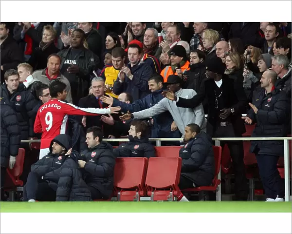 Eduardo (Arsenal) shakes hands with Cesc Fabregas