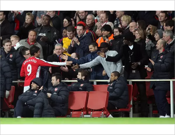 Eduardo (Arsenal) shakes hands with Cesc Fabregas