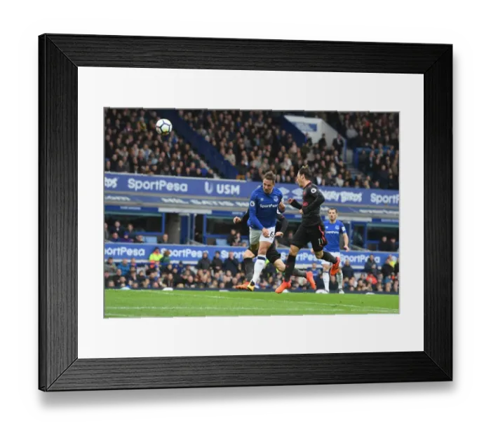 Framed Print : Mesut Ozil Soars High: The Thrilling Moment of His Header Against Everton (2017-18)
