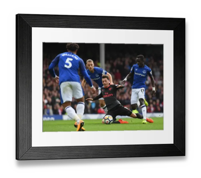Framed Print : Mesut Ozil Fouled by Idrissa Gueye and Nikola Vlasic in Everton vs Arsenal Premier League Clash Framed Print : Mesut Ozil Fouled by Idrissa Gueye and Nikola Vlasic in Everton vs Arsenal Premier League Clash