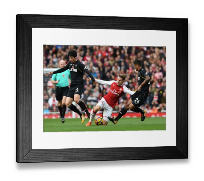 Framed Print : Arsenal's Aaron Ramsey Faces Off Against Ki Sung-Yeung and Kyle Naughton of Swansea during the 2017-18 Premier League Match Framed Print : Arsenal's Aaron Ramsey Faces Off Against Ki Sung-Yeung and Kyle Naughton of Swansea during the 2017-18 Premier League Match
