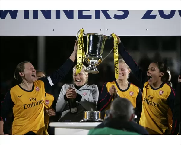 Jayne Ludlow and Alex Scott (Arsenal) lift the League Cup Trophy
