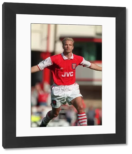 Dennis Bergkamp celebrates scoring his first goal for Arsenal