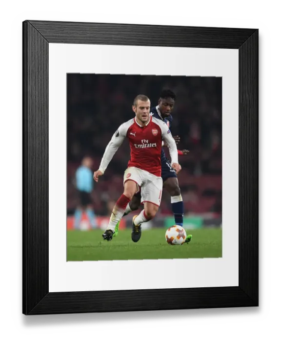 Framed Print : Clash of Midfielders: Jack Wilshere vs. Richmond Donald in Arsenal's Europa League Battle
