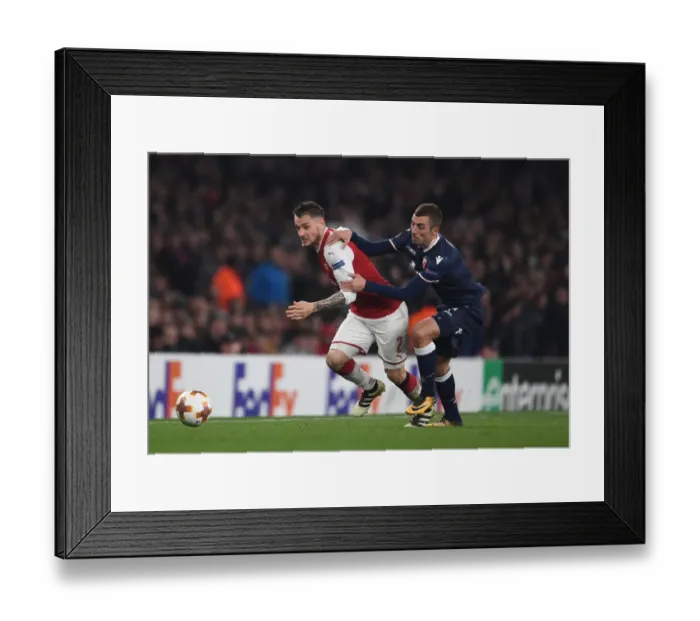 Framed Print : Debuchy vs. Krsticic: A Europa League Battle at Emirates Stadium