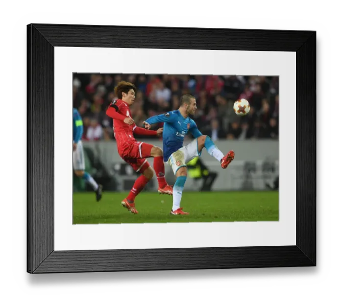 Framed Print : Jack Wilshere Faces Off Against Yuya Osako in UEFA Europa League Clash