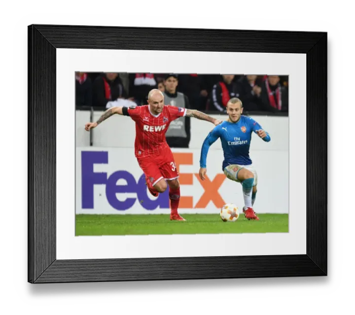 Framed Print : Jack Wilshere vs. Konstanin Rausch: Battle in the Europa League between Arsenal and 1. FC Koln
