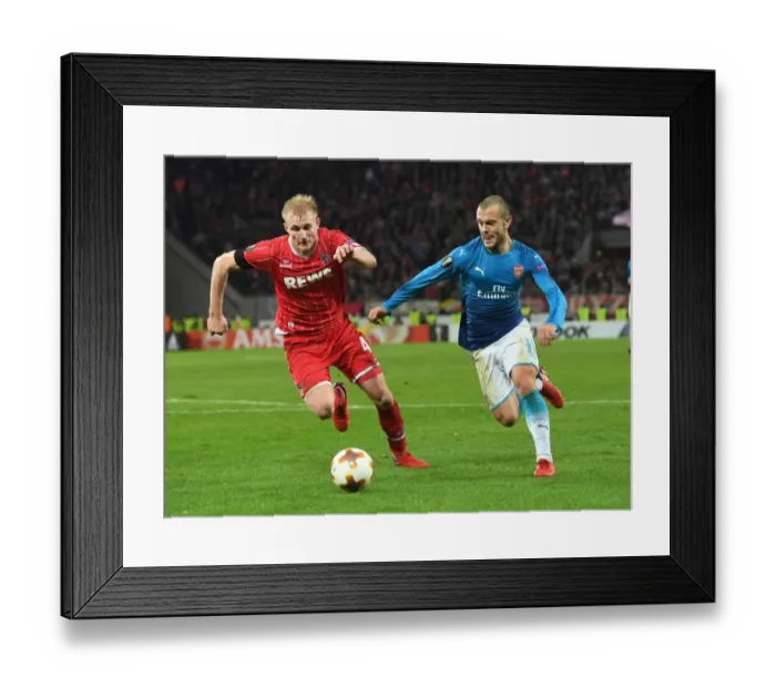 Framed Print : Jack Wilshere's Agile Outmaneuver of Fredrik Sorensen: A Thrilling Moment from Arsenal's Europa League Battle against FC Koln