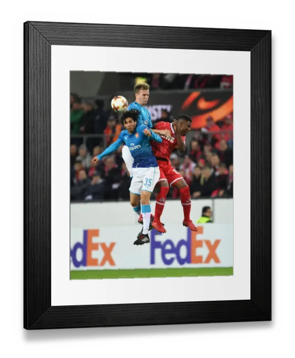Framed Print : Elneny and Holding Clash with Guirassy in Arsenal's Europa League Encounter against FC Koln