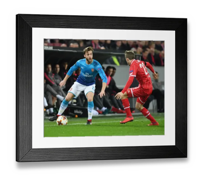 Framed Print : Clash of Defenders: Chambers vs. Horn in Arsenal's Europa League Battle against 1. FC Koln