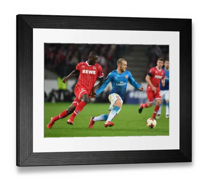 Framed Print : Jack Wilshere vs. Sehrou Guirassy: Battle in the Europa League between Arsenal and 1. FC Koln