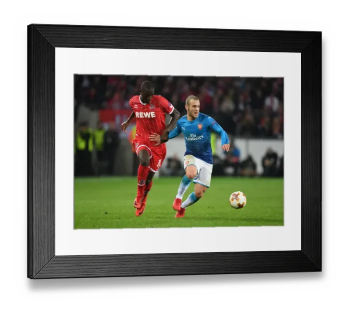 Framed Print : Clash of Midfield Maestros: Jack Wilshere vs. Sehrou Guirassy - FC Koln vs. Arsenal, UEFA Europa League Framed Print : Clash of Midfield Maestros: Jack Wilshere vs. Sehrou Guirassy - FC Koln vs. Arsenal, UEFA Europa League