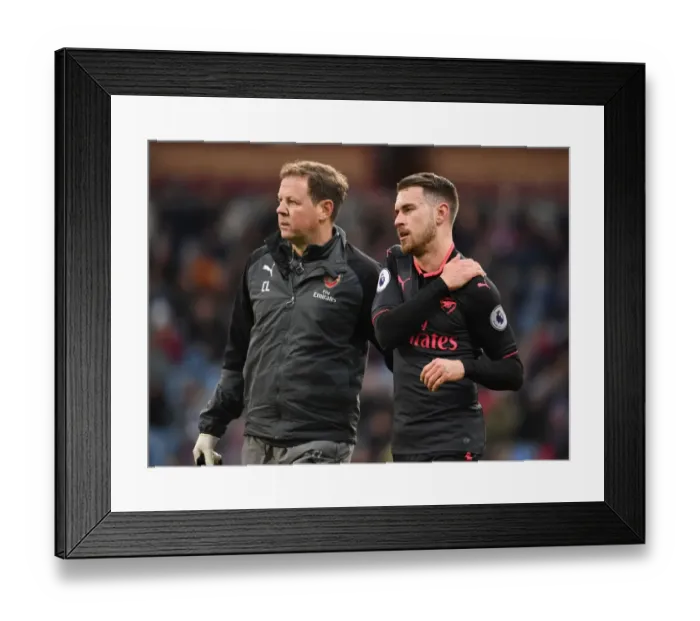 Framed Print : Arsenal's Colin Lewin Attends to Injured Aaron Ramsey during Burnley Match