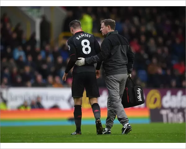 Aaron Ramsey Injured: Arsenal's Midfielder Carried Off the Pitch by Physio Colin Lewin During Burnley vs Arsenal Match