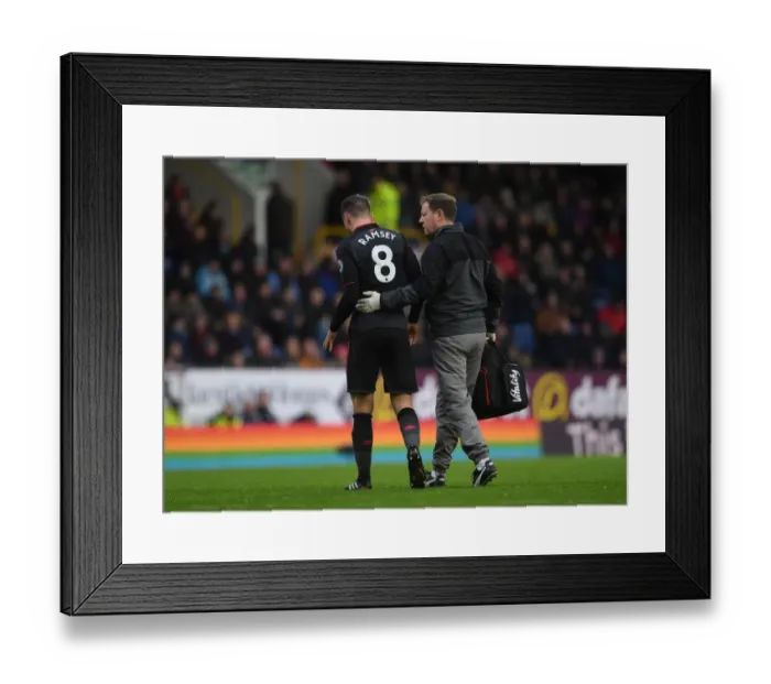 Framed Print : Aaron Ramsey Injured: Arsenal's Midfielder Carried Off the Pitch by Physio Colin Lewin During Burnley vs Arsenal Match Framed Print : Aaron Ramsey Injured: Arsenal's Midfielder Carried Off the Pitch by Physio Colin Lewin During Burnley vs Arsenal Match