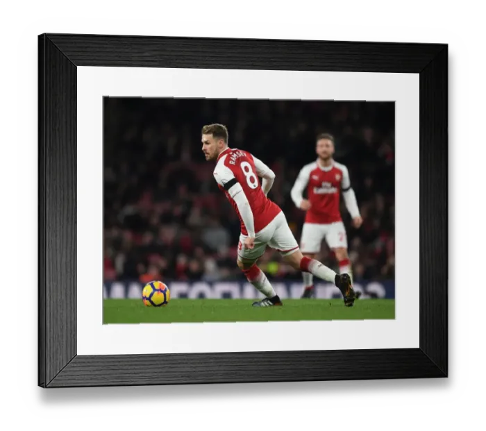 Framed Print : Arsenal's Aaron Ramsey Shines: Crushing Huddersfield Town in Premier League Clash