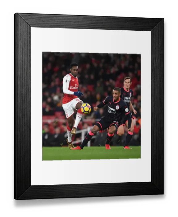 Framed Print : Arsenal's Welbeck Faces Off Against Huddersfield's Jorgensen in Premier League Clash