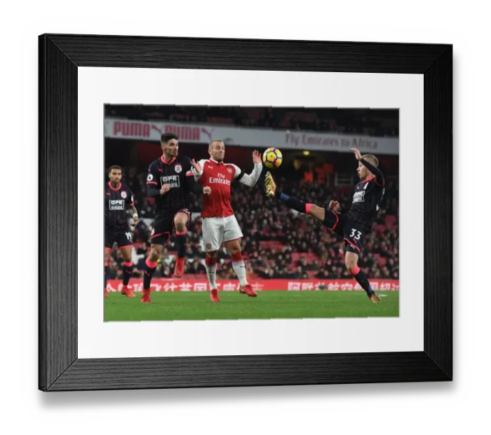 Framed Print : Arsenal's Jack Wilshere Goes Head-to-Head with Schindler and Hadergjonaj in Intense Premier League Showdown Framed Print : Arsenal's Jack Wilshere Goes Head-to-Head with Schindler and Hadergjonaj in Intense Premier League Showdown